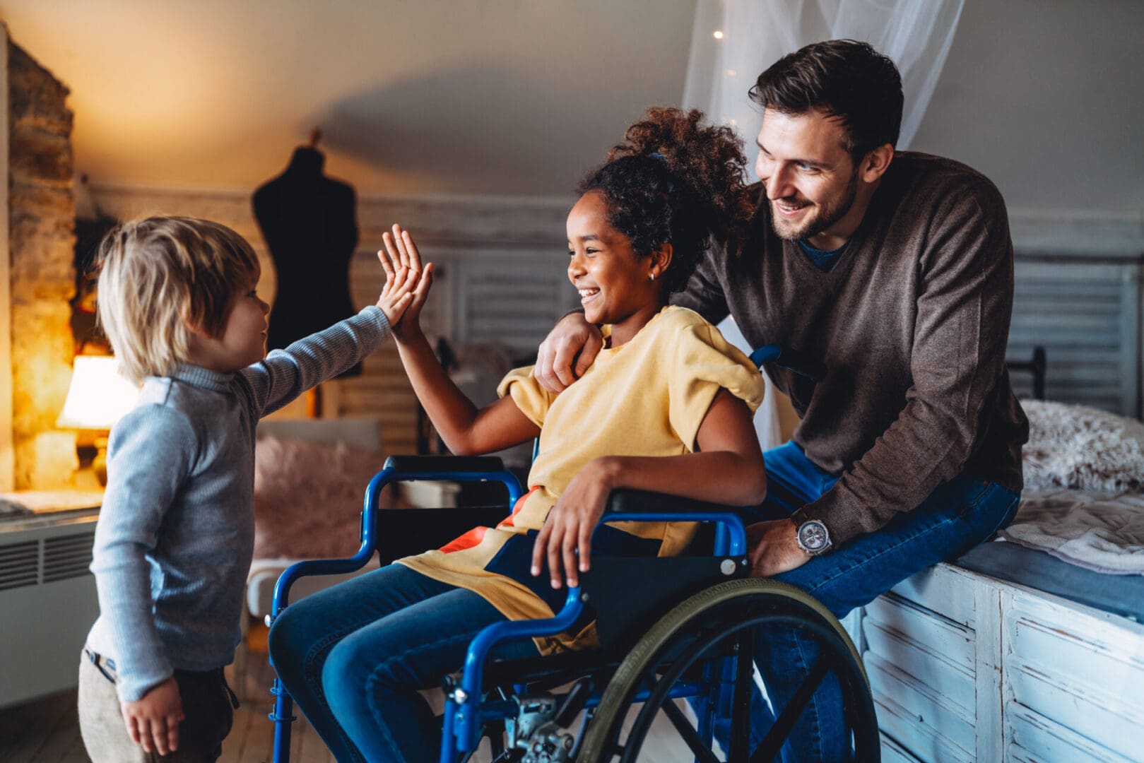 A man and woman in a wheelchair with two children.